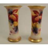 A pair of Royal Worcester spill vases, with flared necks, decorated with blackberries and autumn