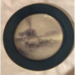 A Royal Worcester plate, decorated with sheep in a winter landscape, to a blue border by H Davis,