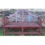 A modern 18th century style garden bench, with ladder trellis back and scroll arms, width 65ins