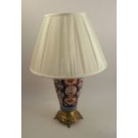 A pair of Imari table lamps, raised on pierced gilt circular bases, together with lamp shades,