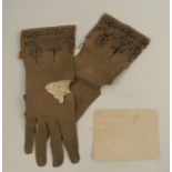 A pair of 18th century ladies leather gloves, with silver wire work decoration, together with a note