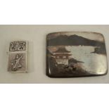A white metal niello work cigarette case, decorated with pagodas in a landscape to the exterior