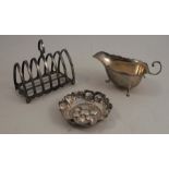 A silver toast rack, Sheffield 1922, together with a silver sauce boat, Sheffield 1931, a small