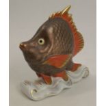 A Herend model, of a fish on a wave-like base, height 4.25ins Condition Report: Inspected and no