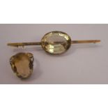 A citrine single stone ring, finger size O, together with a large citrine set bar brooch