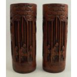 A pair of carved bamboo vases, carved with figures in a forest, height 9.5ins