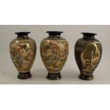 A pair of 20th century Satsuma vases, decorated with figures in landscape, to a dark blue ground,
