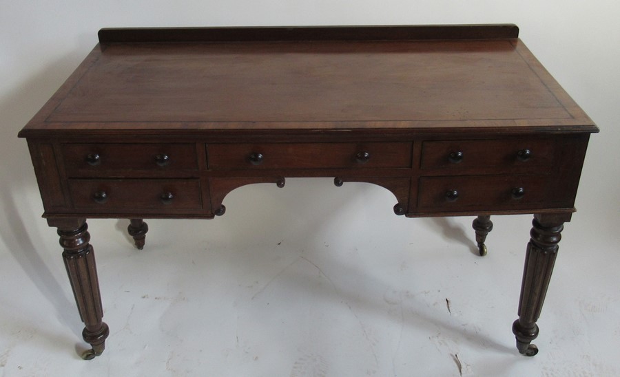 A 19th century mahogany knee hole writing table, in the Gillows style, fitted with one long frieze