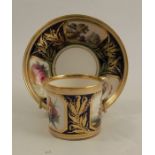 A 19th century Derby coffee can and saucer, decorated with landscape panels and flowers to a blue