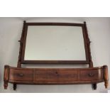 A 19th century mahogany rectangular swing frame toilet mirror, with turned supports, having a
