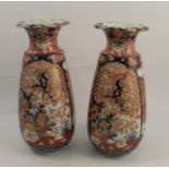 A pair of Oriental Imari vases, decorated in the typical palette with flowers, trees and birds,