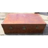 A rectangular leather trunk, being part studded, having four carrying handles and divided