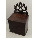 A 19th century oak salt box, with pierced scroll back, having a hinged sloping lid, height 17ins