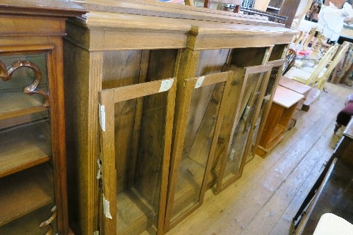 A BREAK FRONT GLAZED CABINET, FITTED WITH ADJUSTABLE SHELVES, HEIGHT 54INS X WIDTH 72INS X DEPTH