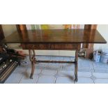 A mahogany sofa table, fitted with two real and two dummy frieze drawers, raised on end lyre