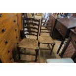 A PAIR OF LADDER BACK COUNTRY STYLE CHAIRS, WISH RUSH SEATS