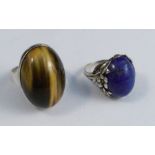 A lapis lazuli ring in the style of Bernard Istone, together with a silver tiger eye ring