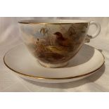 A Royal Worcester breakfast, or over-sized, cup and saucer decorated with quail by Jas Stinton,