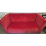 A red settee, with deep sides, width 80ins, depth 40ins