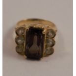 A smoky quartz white stone dress ring, in unmarked yellow gold, tests as 18 carat gold, finger