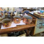 A SET OF THREE GRADUATED COPPER PANS, DIAMETERS 10INS, 7INS AND 7.5INS, STAMPED LEON JAEGGI &