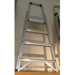 A four tread metal step ladder