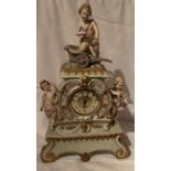 A continental porcelain clock, applied with putti and figures, height 18ins