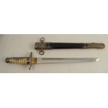 A decorative dagger and sheath, with shagreen effect handle and brass mounts, the leather sheath