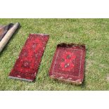 TWO SMALL RED GROUND RUGS, 39INS X 18INS AND 19.5INS X 24INS, TOGETHER WITH ANOTHER RUG, 37INS X
