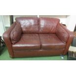 A leather two seater sofa, width 60ins approx