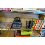 A SHELF TO INCLUDE BOOKS, ANNUALS, TOGETHER WITH JIGSAWS AND REMOTE CONTROL DRIVING TEST