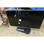 A PANASONIC FLAT SCREEN TELEVISION, TESTED, TOGETHER WITH REMOTE