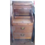 An oak roll top desk, with serpentine roll top, over a pull out writing surface and two drawers