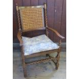 An antique Carolean style walnut bergere open armchair, with all over barley twist turnings and