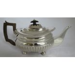 A 19th century silver tea pot, with gadrooned rim and lover body, raised on four ball feet, engraved