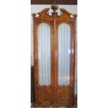 A 19th century burr walnut glazed door cabinet, the interior fitted with adjustable shelves, below a