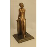 A Lorenzl patinated spelter table lighter, modelled as a nude leaning on a column, height 8.