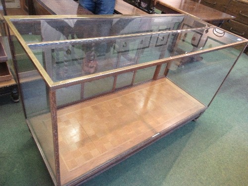 A brass, wood and glass shop counter display unit, by Sage & Co, with sliding glass doors, width