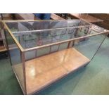 A brass, wood and glass shop counter display unit, by Sage & Co, with sliding glass doors, width