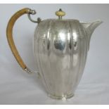 An Edwardian silver coffee pot, the lobed body with a band of engraved decoration, having a wicker