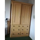 A large 19th century boarded pine cupboard on chest, having two cupboard doors opening to reveal