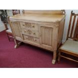 A sideboard, having three drawers flanked by two cupboards, with side column supports, width 54ins x