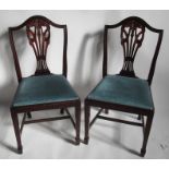 A set of fourteen reproduction mahogany dining chairs, with carved backs and drop in seats
