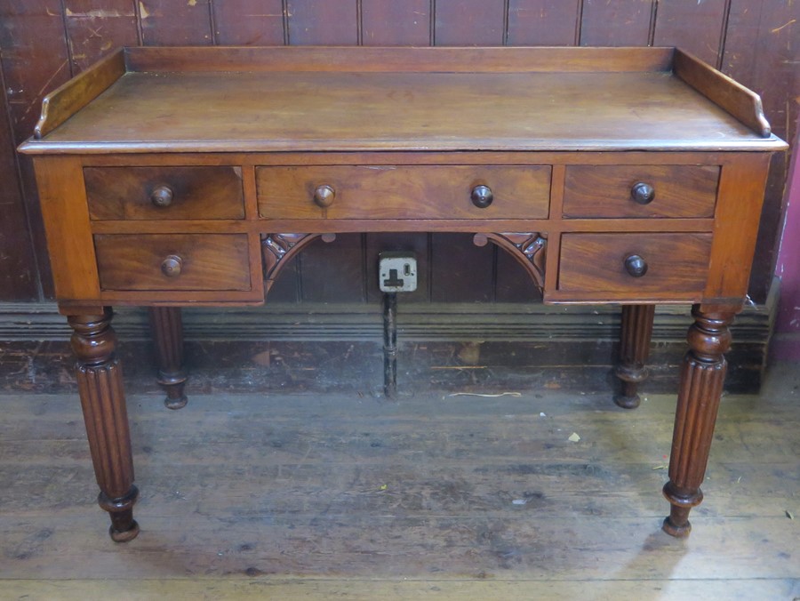 A 19th century mahogany tray top wash stand, fitted with a central drawer, flanked by two short