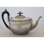 36290 A late Victorian silver tea pot, with gadrooned and engraved decoration, engraved with