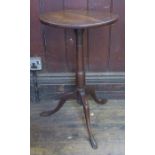 An antique circular occasional table, raised on a slender column terminating in a tripod base,