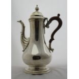 A silver coffee pot, of baluster form, with leaf moulding to the spout, Birmingham 1969, maker J B