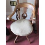 A late Victorian swivel office chair, of hoop back form