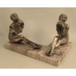 A pair of silver plated bookends, modelled as seated girls holding flowers, on marble bases,