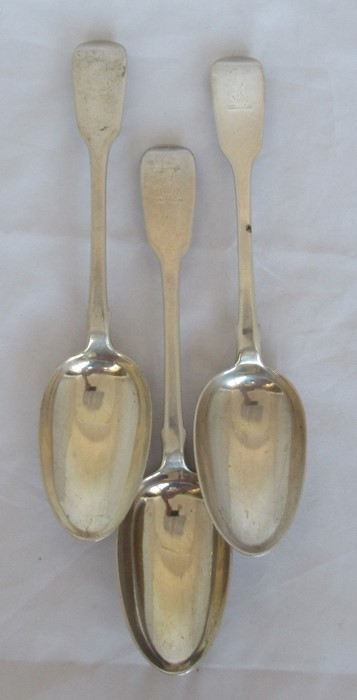 Three Georgian silver fiddle pattern serving spoons, engraved with a crest, London 1836, maker